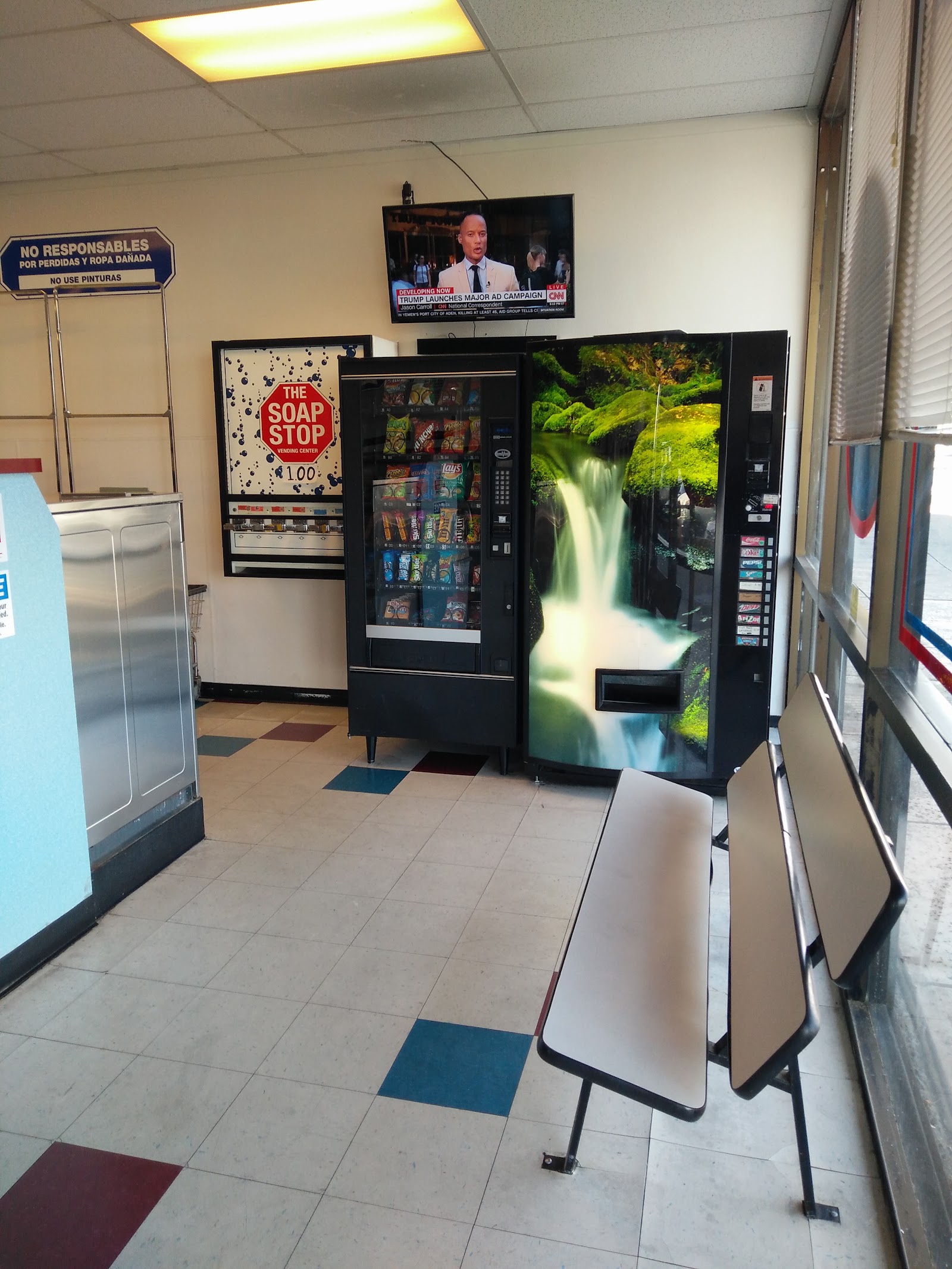 Vending area with snack and drink machines, soap vending, seating and a wall-mounted TV